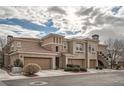 View of building's exterior, showing multiple units with garages at 10809 Garden Mist Dr # 2093, Las Vegas, NV 89135