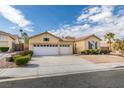 House exterior featuring a three-car garage and landscaped front yard at 2297 Aria Dr, Henderson, NV 89052