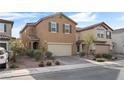 Two-story house with tan exterior, two-car garage, and landscaping at 2932 Torreon Ln, Las Vegas, NV 89121