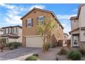 Two-story house with tan exterior, two-car garage, and landscaping at 2932 Torreon Ln, Las Vegas, NV 89121
