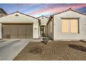 Charming single-story home featuring a two-car garage, desert landscaping, and tile roof at 3740 Corte Bella Hills Ave, North Las Vegas, NV 89081