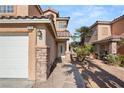 Front entry with walkway leading to a two-car garage at 4712 Stable Way, North Las Vegas, NV 89032