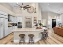 Bright kitchen boasts a large island with bar seating, white cabinetry, and stainless steel appliances at 520 Summer Mesa Dr, Las Vegas, NV 89144