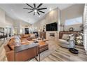 Spacious living room features a fireplace, large windows, and a comfortable leather sectional at 520 Summer Mesa Dr, Las Vegas, NV 89144