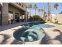 Backyard features a pool and spa surrounded by palm trees, creating a serene outdoor space at 520 Summer Mesa Dr, Las Vegas, NV 89144