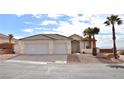 Two-car garage, desert landscaping, and a two-story home with a tile roof at 53 Flowering Desert Dr, Palm Gardens, NV 89039