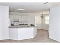 Spacious kitchen with granite countertops and white cabinets at 53 Flowering Desert Dr, Palm Gardens, NV 89039