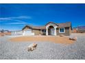 Beautiful single-story home with desert landscaping, a two-car garage and bright entry way at 5841 Genoa Ave, Pahrump, NV 89060