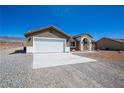 Charming single-story home featuring a spacious two-car garage and desert landscaping at 5841 Genoa Ave, Pahrump, NV 89060