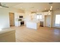 Open-concept kitchen with white cabinetry, a center island, and stainless steel appliances at 5841 Genoa Ave, Pahrump, NV 89060