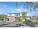 Beautiful two-story home featuring a well-manicured lawn and a three-car garage at 65 Garibaldi Way, Henderson, NV 89011