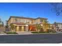 Charming two-story home with a driveway and a lush landscaped front yard at dusk at 65 Garibaldi Way, Henderson, NV 89011