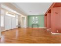 Spacious living room featuring hardwood floors, neutral paint, and ample natural light from large windows at 6545 Candleglade Ct, North Las Vegas, NV 89084