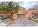 Two-story house with neutral color scheme and landscaped front yard at 7481 Benlomond Ave, Las Vegas, NV 89179