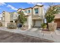 Two-story house with balcony, attached garage, and landscaping at 7660 Fabled Filigree St, Las Vegas, NV 89149