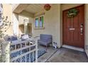 Cozy front porch with seating and welcoming decor at 7660 Fabled Filigree St, Las Vegas, NV 89149