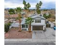 Two-story house, palm trees, and a view of the neighborhood at 881 Stonehenge St, Las Vegas, NV 89110