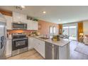 Modern kitchen with white cabinets and quartz countertops at 10164 Mulberry Ridge St # 42, Las Vegas, NV 89141