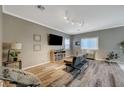 Living room features wood-look floors and a modern fireplace at 10191 Cougar Crossing St, Las Vegas, NV 89178