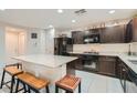 Modern kitchen with granite countertops and dark wood cabinets at 10548 Seasonable Dr, Las Vegas, NV 89129