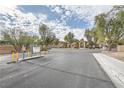 Community parking lot with signage and landscaping at 2051 Hussium Hills St # 207, Las Vegas, NV 89108