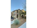 Two-story home featuring a balcony, neutral paint, and desert landscaping with desert plants at 3041 Savella Ave, Henderson, NV 89044