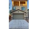 Two-story home featuring a two-car garage, balcony, and desert landscaping at 3041 Savella Ave, Henderson, NV 89044