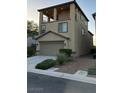 Tan three-story house with a balcony and garage at 3041 Savella Ave, Henderson, NV 89044