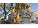 Two-story home featuring a two-car garage, balcony, and desert landscaping at 3041 Savella Ave, Henderson, NV 89044