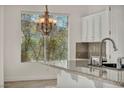 Kitchen with granite countertops and white cabinets at 37 Stonemark Dr, Henderson, NV 89052