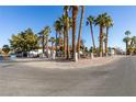 Residential property situated on a corner lot with palm trees at 3990 Melody Ln, Las Vegas, NV 89108