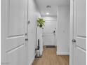 Bright entryway with wood floors, white doors, and a plant at 4070 Emerald Wood St, Las Vegas, NV 89115