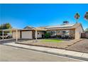 House exterior showcasing a carport, solar panels, and well-maintained landscaping at 4089 Patterson Ave, Las Vegas, NV 89104