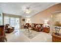 Spacious living room featuring a brown couch and tile flooring at 4089 Patterson Ave, Las Vegas, NV 89104