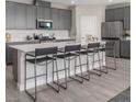 Modern kitchen with gray cabinetry, white countertops, and a large island at 4181 Nopal Serrano Ave, Las Vegas, NV 89141