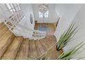 Bright entryway featuring a gracefully curved staircase with wooden treads and white risers, leading to the upper level at 4330 Flandes St, Las Vegas, NV 89121