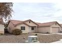 One-story house with terracotta tile roof and neutral color scheme at 4618 Zia Ridge St, North Las Vegas, NV 89031