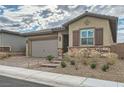 Single-story home with a two-car garage and landscaped front yard at 473 Harvest Rain Ave, Henderson, NV 89011