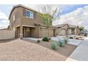 Two-story house with a two-car garage, landscaping, and a view of the neighborhood at 521 Abrazar Ave, North Las Vegas, NV 89081