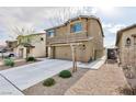 Two-story house with a two-car garage and landscaping at 521 Abrazar Ave, North Las Vegas, NV 89081