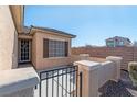 Small front patio with a gate leading to the front door at 6420 Birdcall St, North Las Vegas, NV 89084