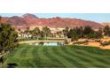 Tuscan-style golf course with a pond and mountain views at 685 Viale Machiavelli Ln, Henderson, NV 89011