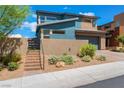 Stylish two-story home, gray and blue exterior, landscaped yard at 7230 Galaxy Dune St, Las Vegas, NV 89148