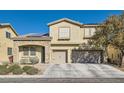 Two-story house with tan exterior, stone accents, and a two-car garage at 7528 Stray Horse Ave, Las Vegas, NV 89113