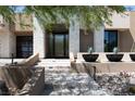 Front entrance with modern door, stone veneer, and landscape at 78 Hawk Ridge Dr, Las Vegas, NV 89135