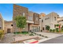 Contemporary home with stone exterior and a landscaped front yard at 821 Barrhead Ave, Henderson, NV 89012