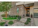 Attractive entryway with stone facade, landscaping, and a welcoming bench at 821 Barrhead Ave, Henderson, NV 89012