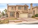 Beige two-story house with attached garage and front yard at 86 Myrtle Beach Dr, Henderson, NV 89074