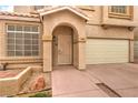 Front entry with decorative door and attached garage at 86 Myrtle Beach Dr, Henderson, NV 89074