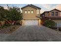 Two-story house with a white garage door at dusk at 9570 Wenmarie Ct, Las Vegas, NV 89148